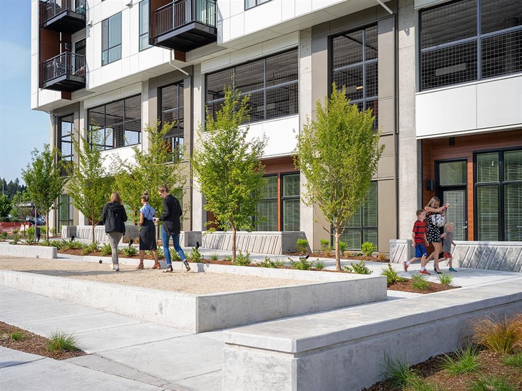 a group of people walking in front of a building