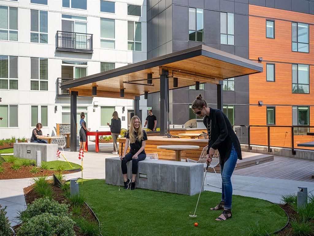 a man and a woman playing golf on a lawn