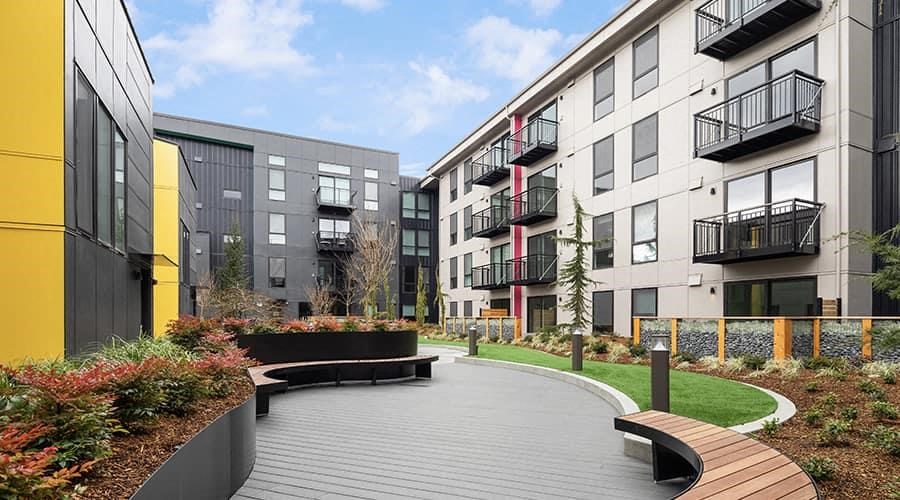 a pathway in the middle of some modern buildings