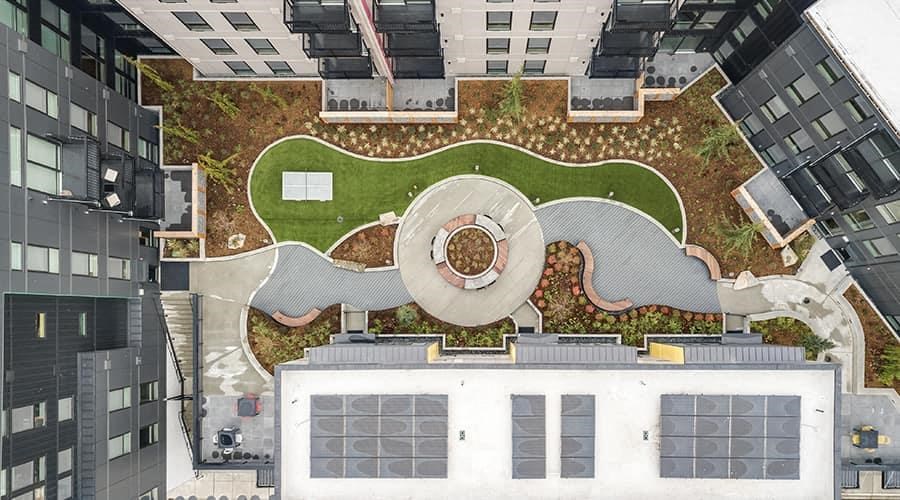 a roof top view of a building with a garden