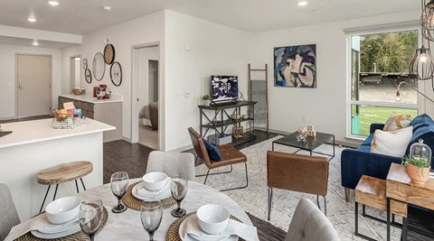 a living room and dining room with a table and chairs