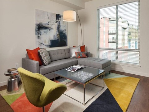 a living room with a couch and chair and a coffee table