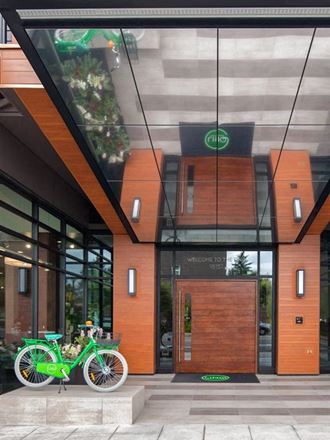 a green bike parked in front of a building