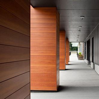 a row of wooden columns on the side of a building