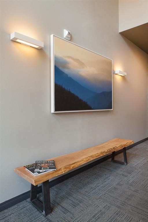 a mirror hanging on a wall above a wooden bench