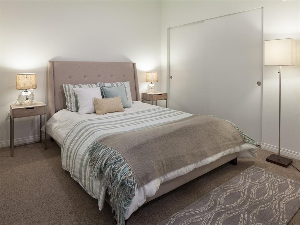 a bedroom with a bed and a closet