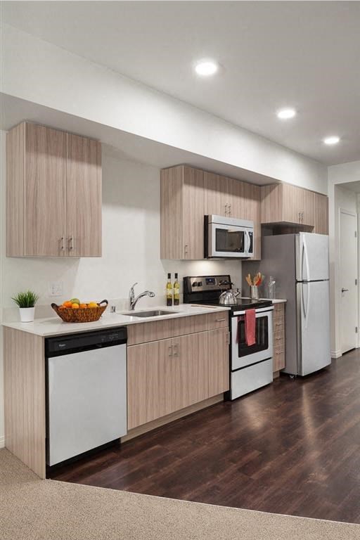 a kitchen with a sink and a stove and a refrigerator