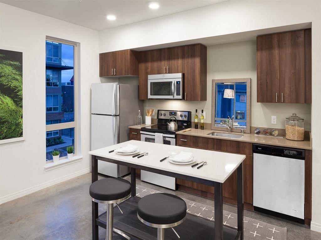 a kitchen with a table and a refrigerator