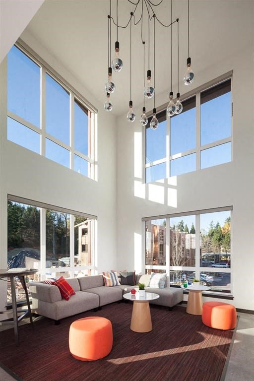 a living room with high ceilings and large windows