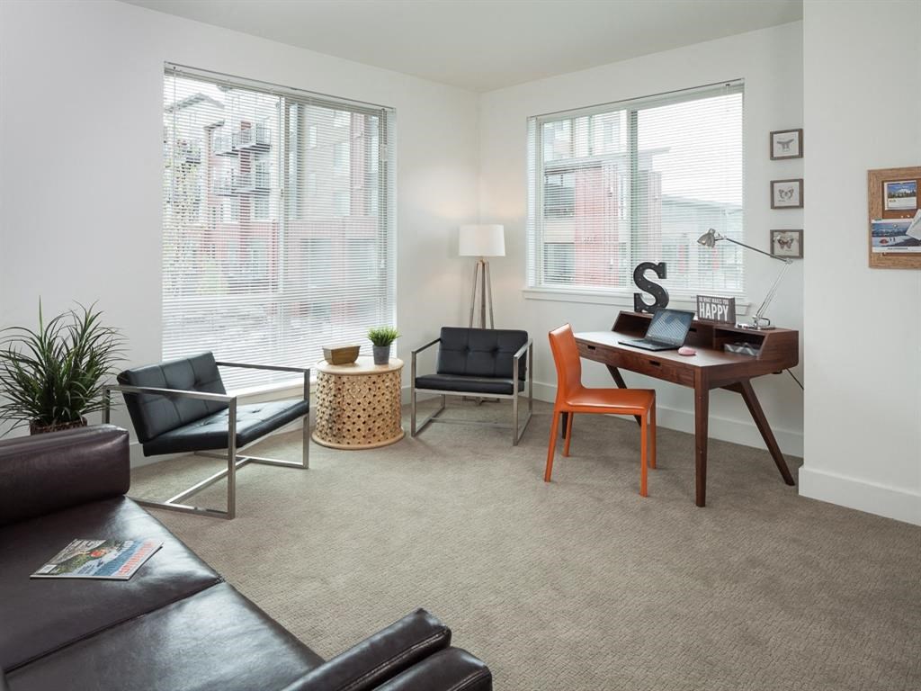 a living room with a couch and a desk
