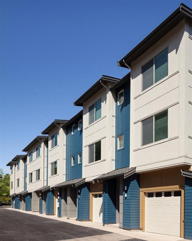 a row of apartment buildings with blue and white doors