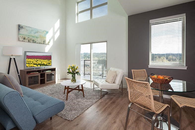 a living room with a couch and chairs and a television