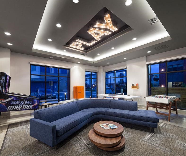 a living room with a blue couch and a table