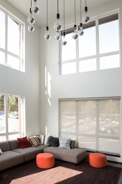 a living room with a couch and some windows