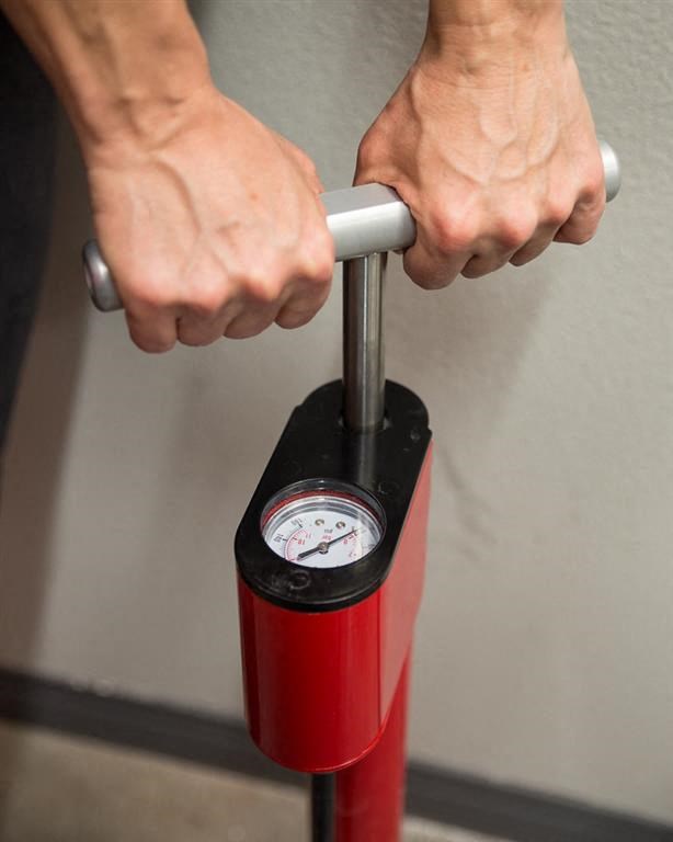 a person holding a handle on a fire extinguisher