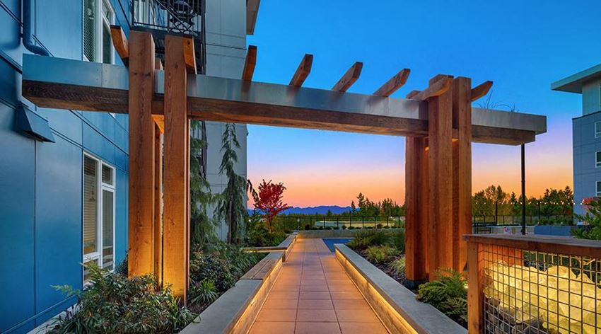 a view of a building with a walkway at sunset