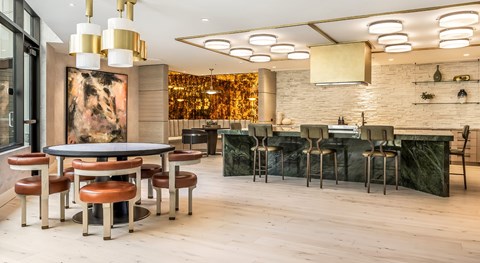 A modern dining area with a large table and chairs.