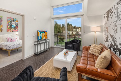 a living room with a couch and a coffee table and a large window