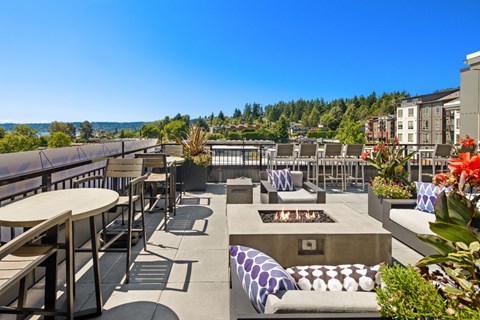 A patio with a fire pit and seating area.