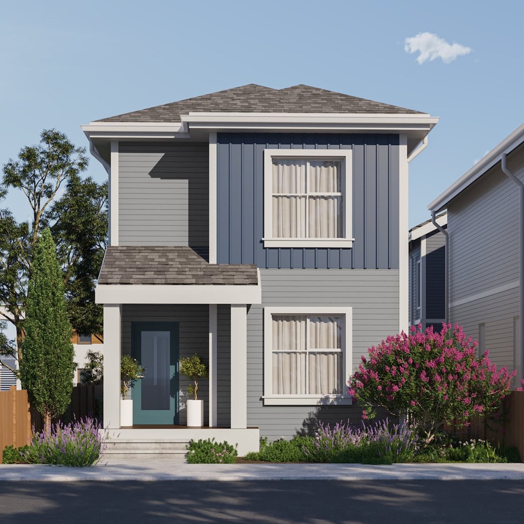 A modern two-story house with a grey exterior and a green door.