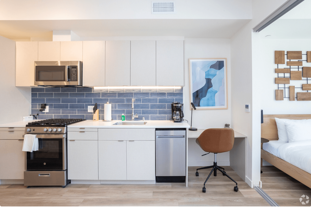 a kitchenette and a bed in a 555 waverly unit
