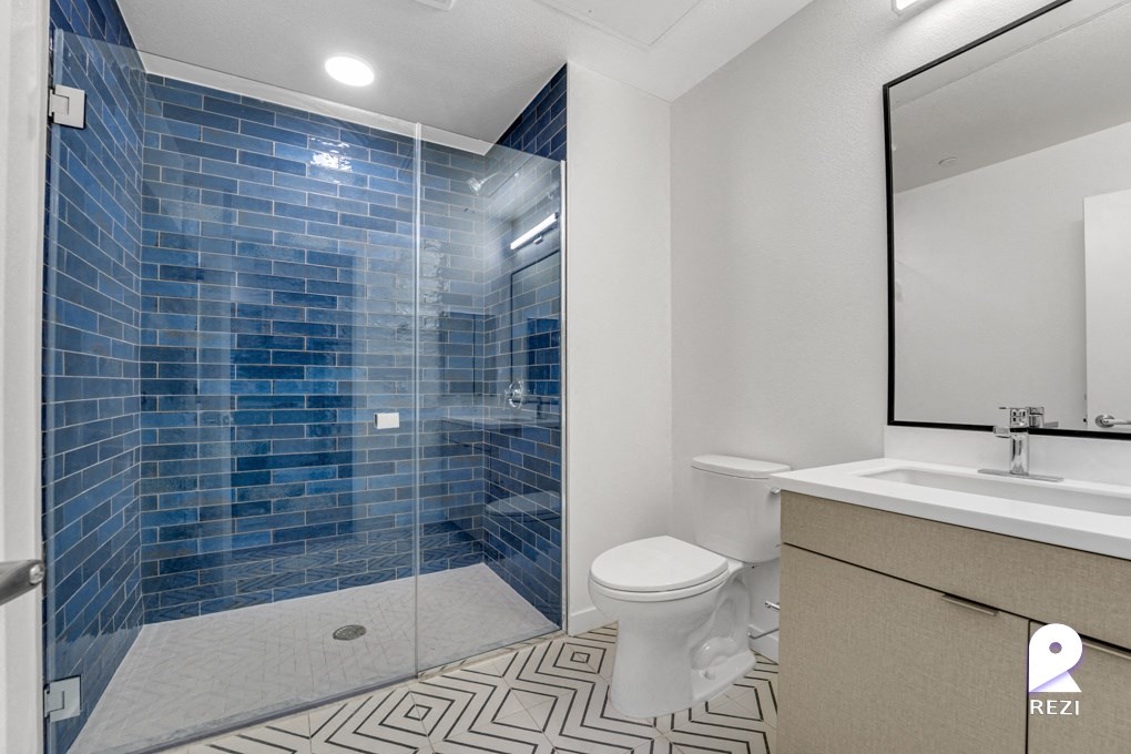 a bathroom with a shower toilet and sink