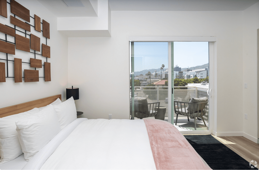 a bedroom with a bed and a window