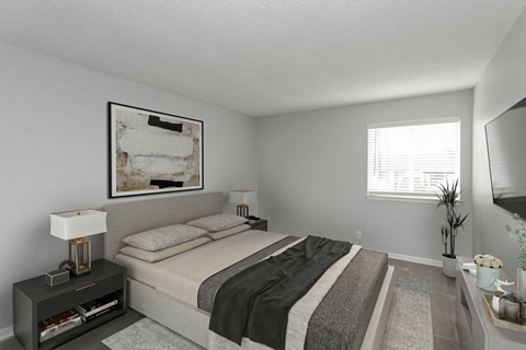 A bedroom with a bed, nightstand, and a painting on the wall.