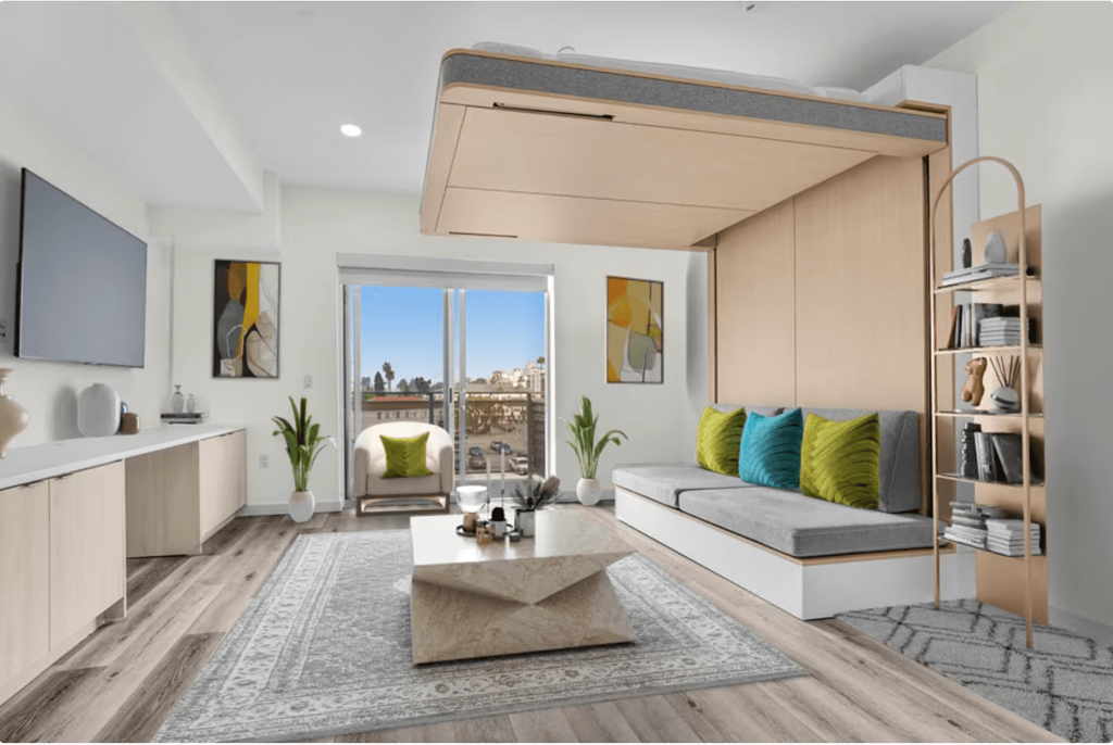 a living room with a couch and a coffee table in front of a window