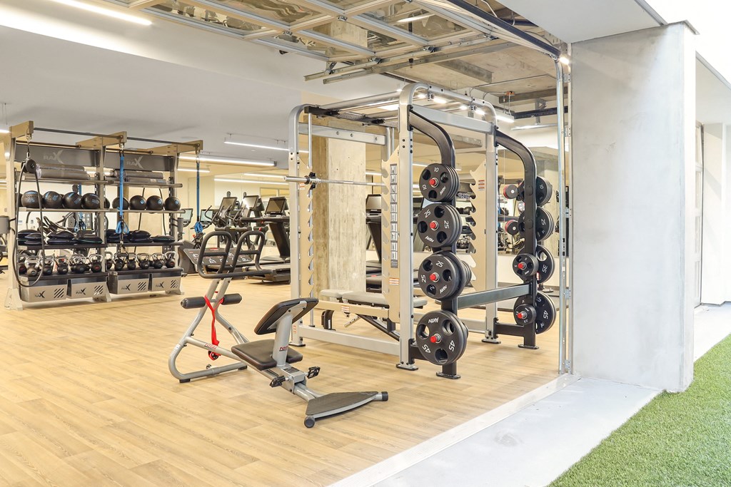 a spacious fitness room with a lot of exercise equipment