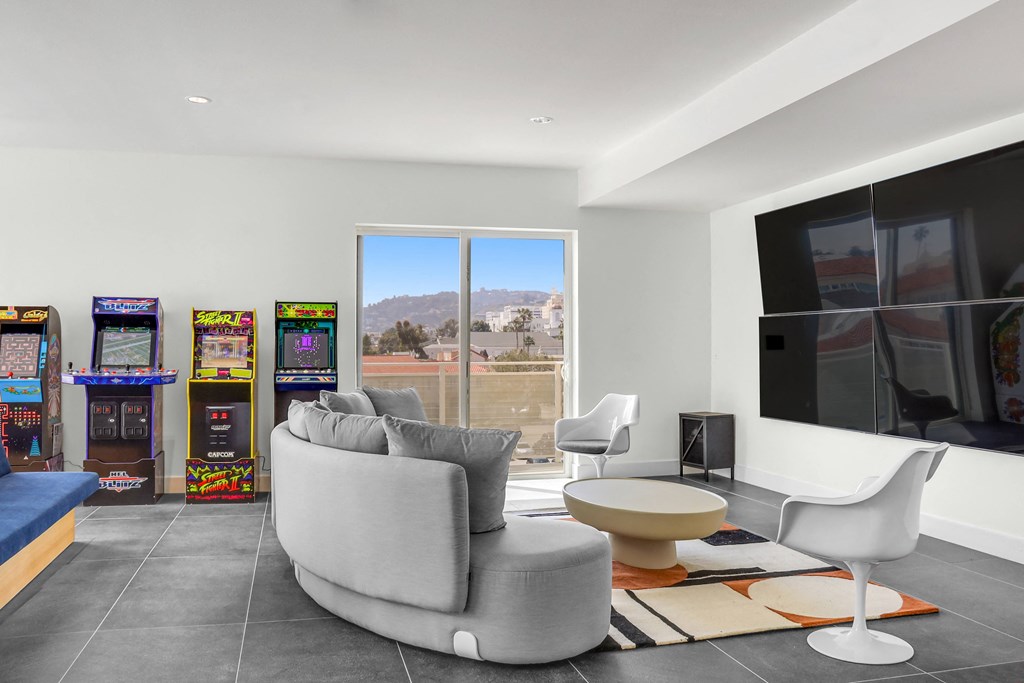 a living room filled with furniture and a flat screen tv