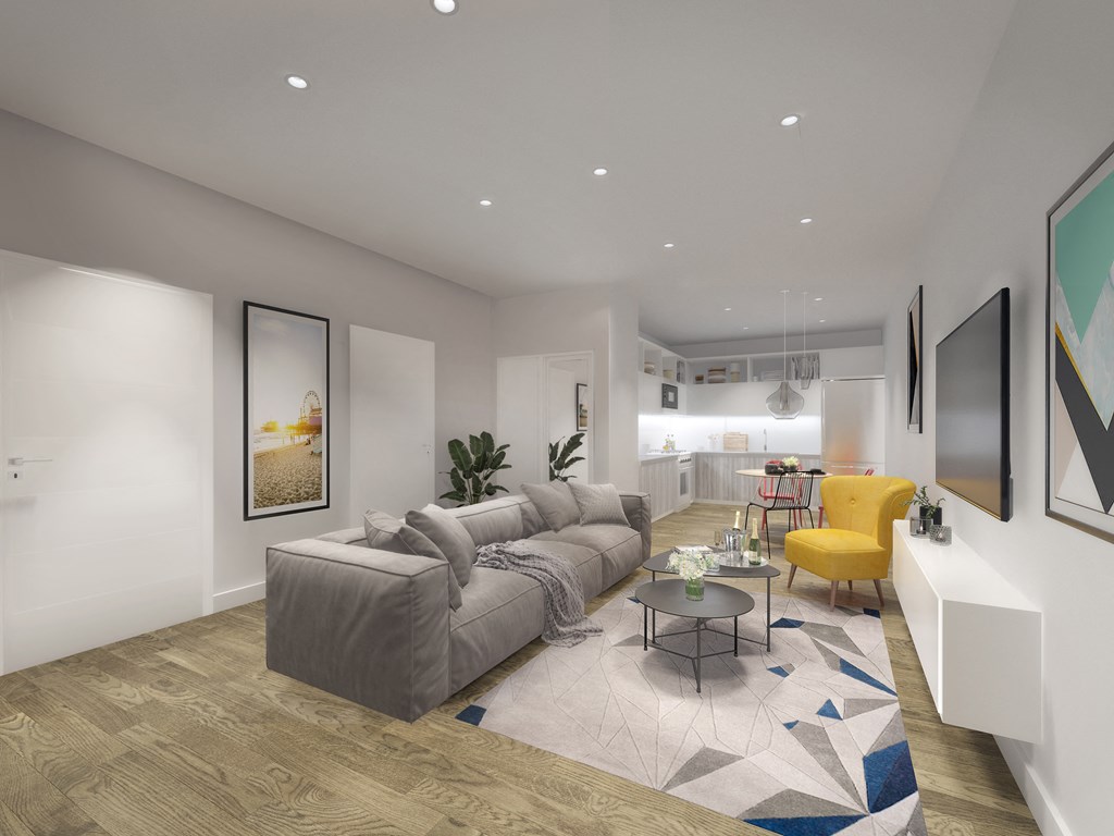 a living room with a gray couch and a yellow chair