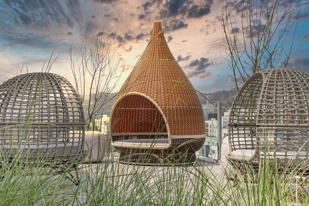 a building with a pointed roof made out of wicker