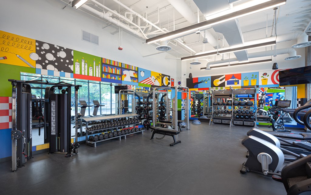 a gym with weights and cardio machines and colorful wall art  at Inspire West Town, CHICAGO, IL, 60642