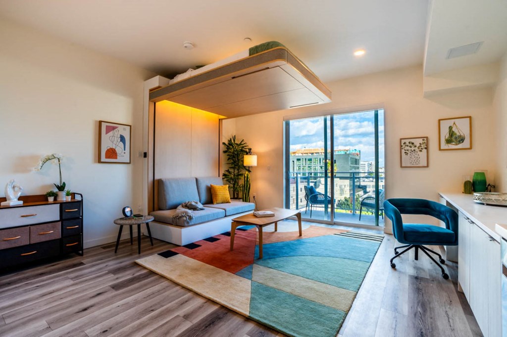 a living room with a couch and a balcony