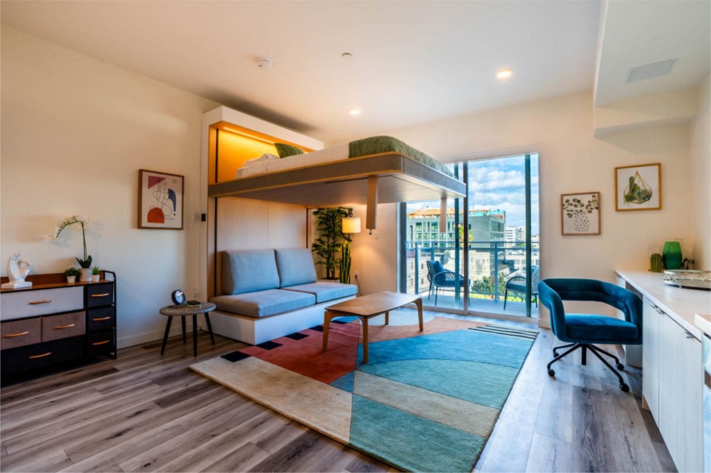a living room with a couch and a balcony