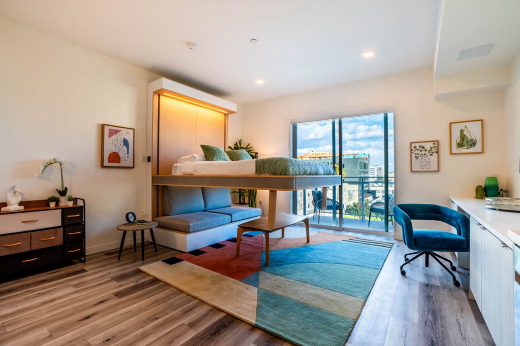 a bedroom with a bunk bed and a balcony