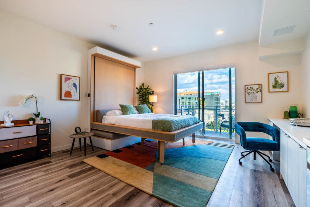 a bedroom with a bed and a balcony