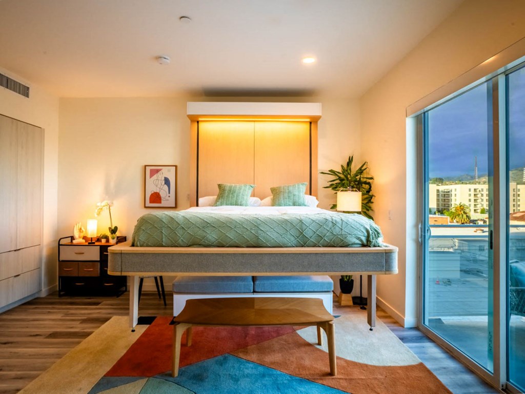 a bedroom with a bed and a sliding glass door