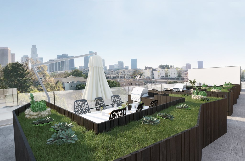 a roof terrace with a city skyline in the background