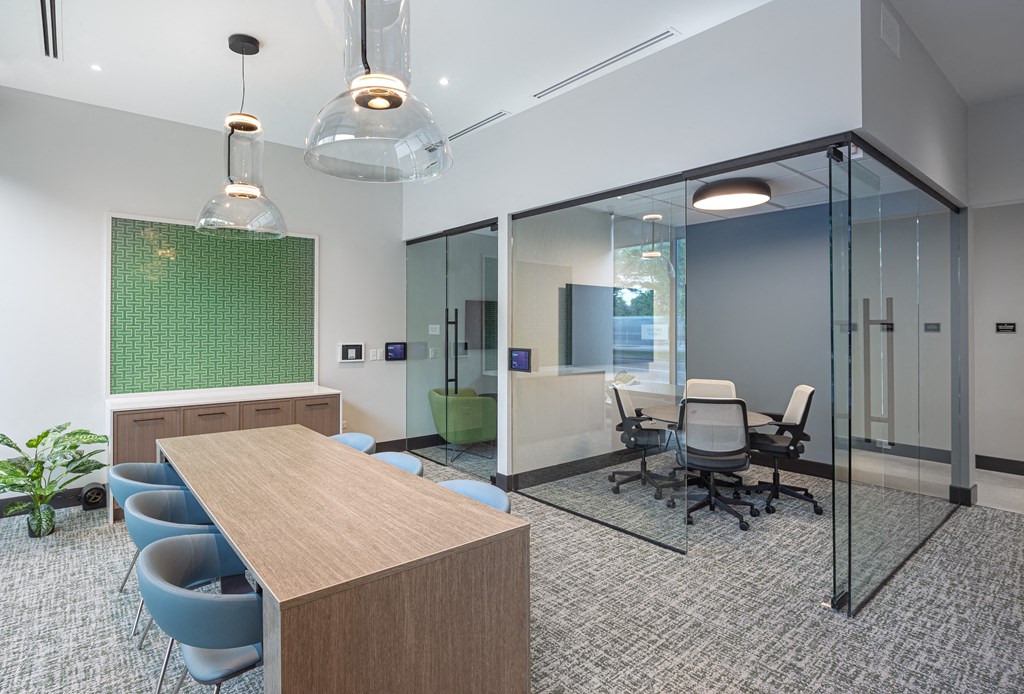 a conference room with glass walls and a table and chairs  at Inspire West Town, CHICAGO, IL, 60642
