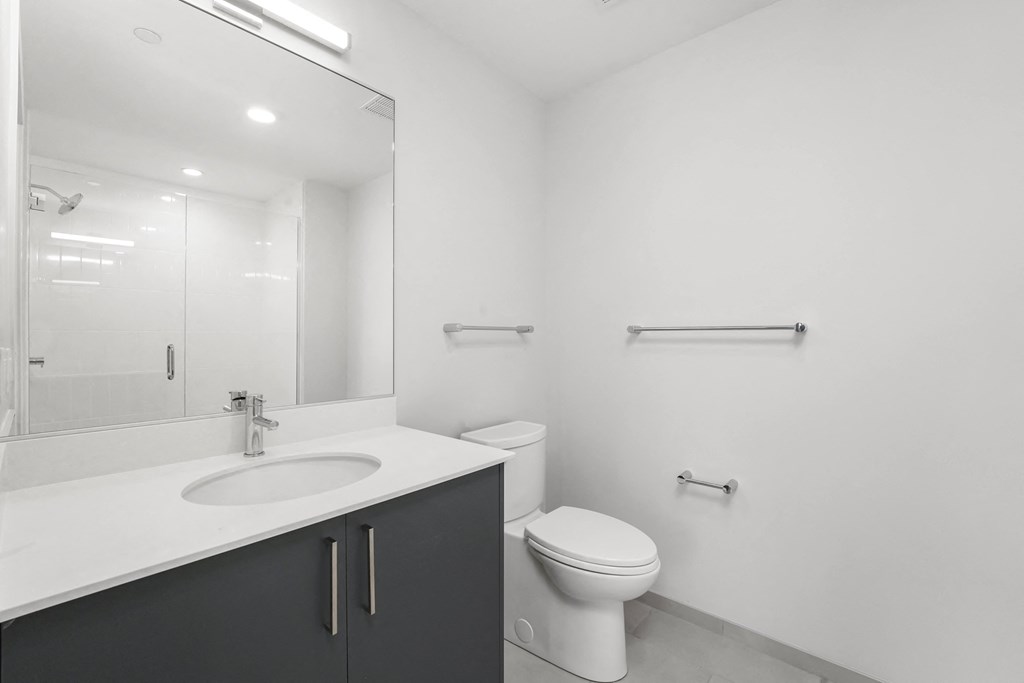 a bathroom with a sink toilet and a mirror  at Inspire West Town, CHICAGO, IL, 60642