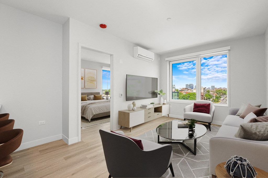a living room with a couch and a coffee table and a bedroom with a bed at Inspire West Town, CHICAGO, Illinois