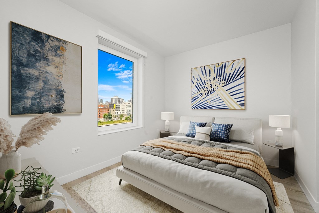 a bedroom with a bed and a large window at Inspire West Town, Illinois
