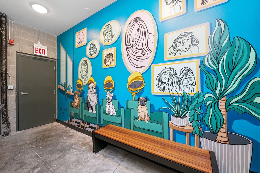 a blue wall with a bench and potted plants in front of it at Inspire West Town in Chicago, IL, 60642