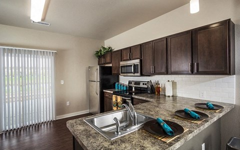 a kitchen with stainless steel appliances and a granite counter top