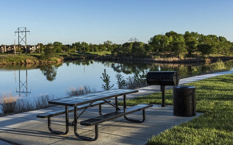 a picnic table next to a body of water