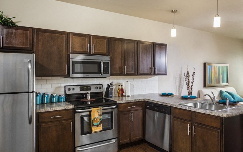 a kitchen with stainless steel appliances and wooden cabinets