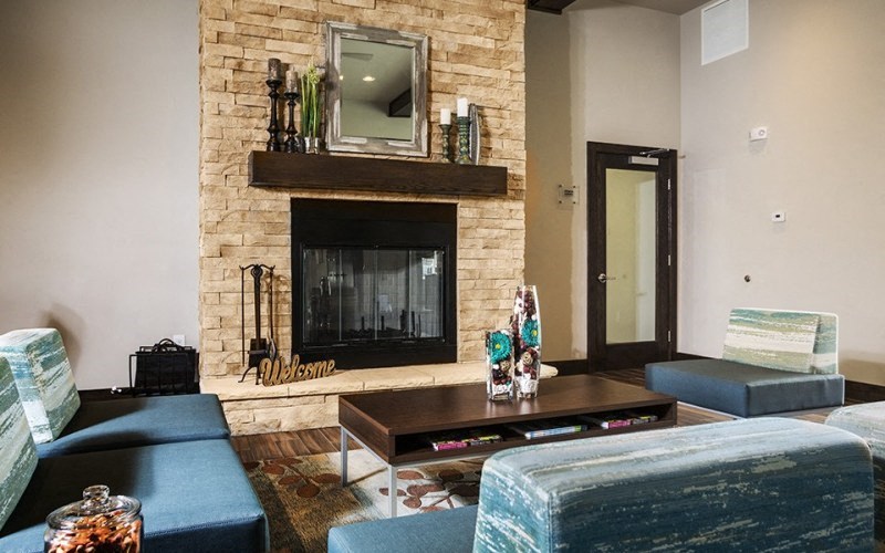 a living room with blue couches and a fireplace