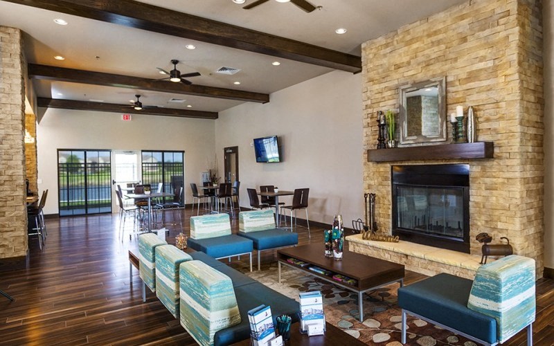 a living room with a fireplace and a table and chairs
